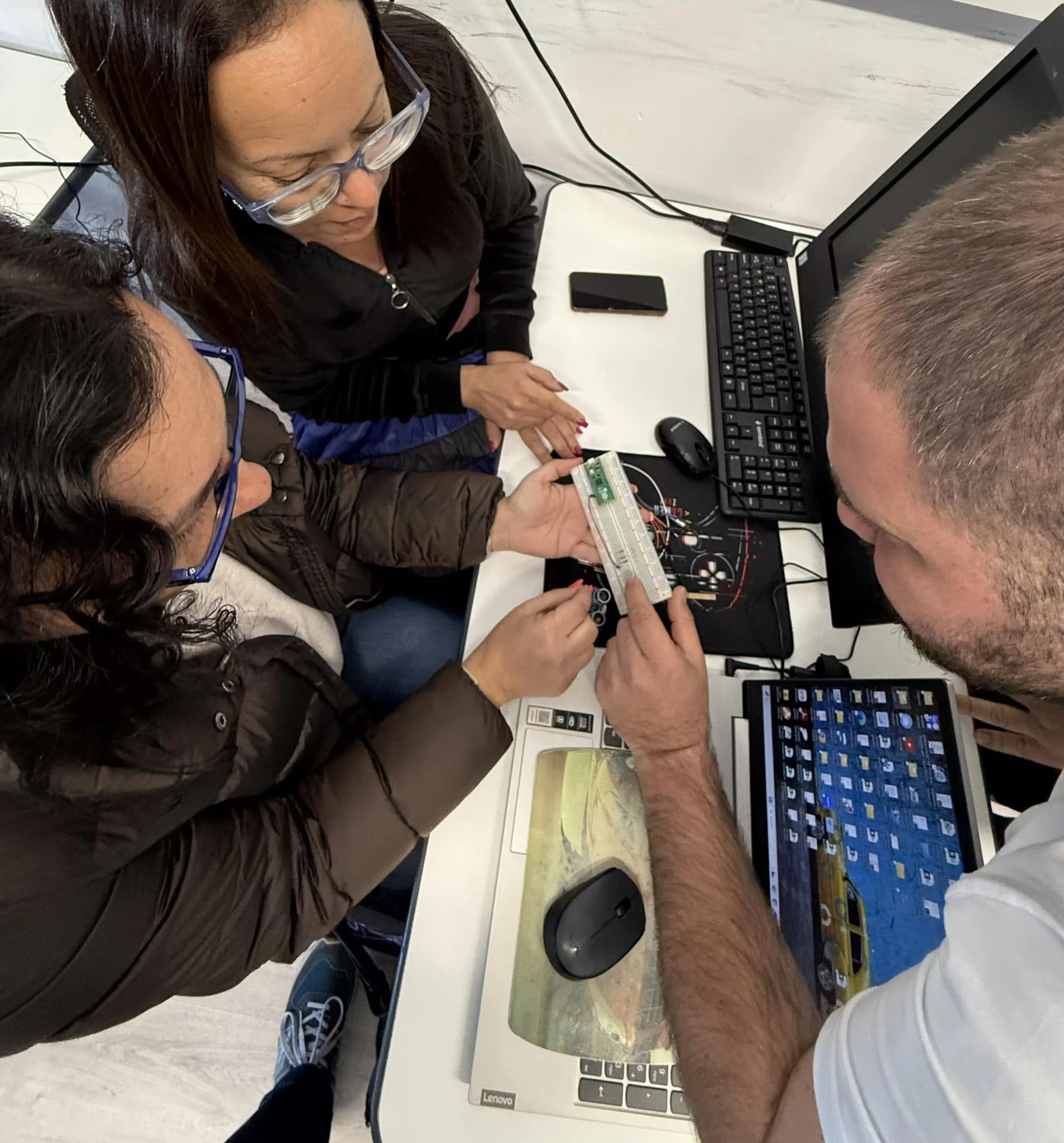 Participants working hands-on with electronics and prototyping tools